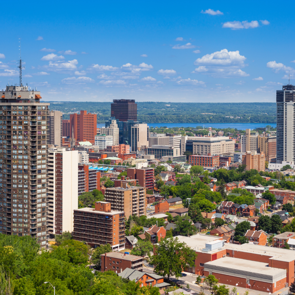 A picture of Hamilton Ontario looking over the buildings and the water in the distance